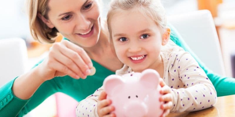 mom teaching kid about saving money