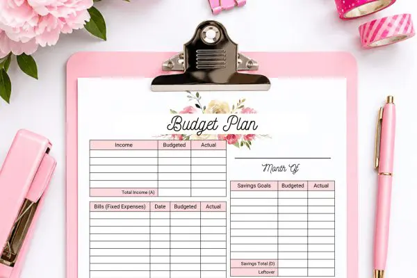 Top of of floral design monthly budget template on pink clipboard