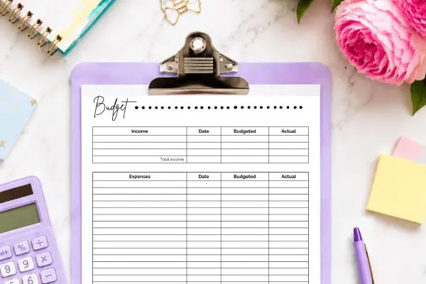 Top half of monthly budget printable on purple clipboard